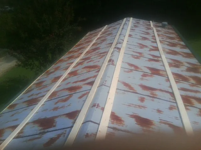 Rusted metal roof panels with new wood purlins before replacement — Storm Damage Roof Repair in Gibbstown by Roofing Brothers