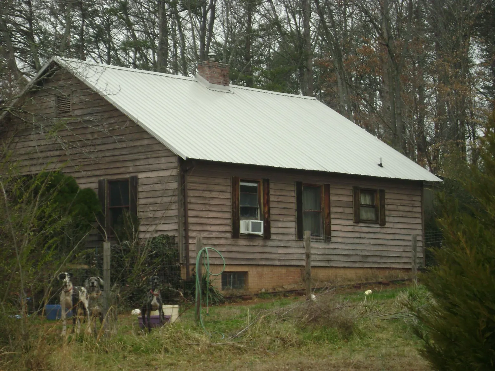 White metal roof on an old wood sided farmhouse, from a Metal Roof Installation job in Gibbstown